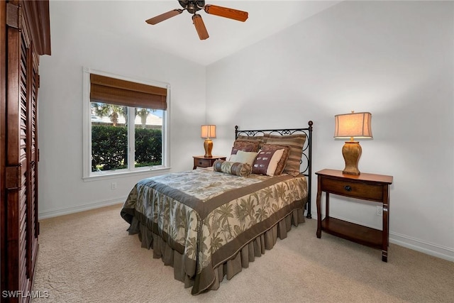 bedroom with baseboards, light carpet, and a ceiling fan