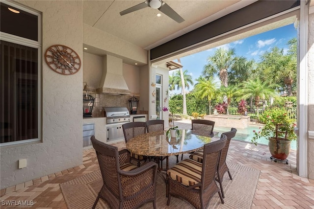 view of patio with outdoor dining area, area for grilling, a ceiling fan, and a pool with connected hot tub