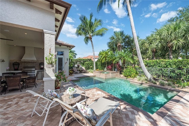 view of pool featuring a patio, fence, an outdoor kitchen, outdoor dining area, and a grill