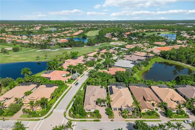 aerial view featuring view of golf course, a water view, and a residential view