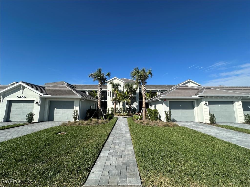 ranch-style house with a garage and a front yard