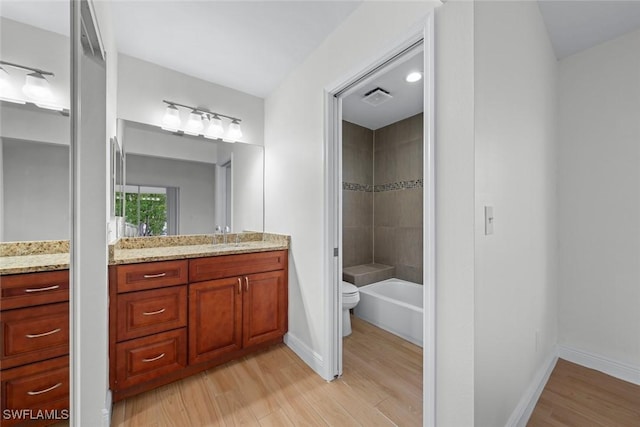 bathroom featuring vanity, hardwood / wood-style flooring, and toilet