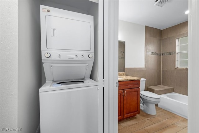 washroom with stacked washer / drying machine