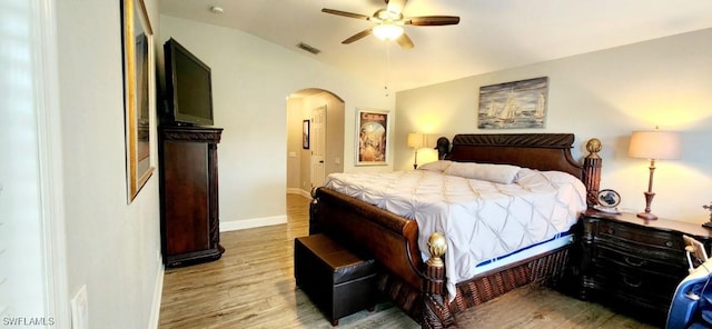 bedroom featuring lofted ceiling, ceiling fan, and light hardwood / wood-style flooring