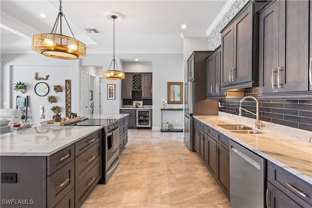 kitchen featuring a large island, appliances with stainless steel finishes, wine cooler, pendant lighting, and sink