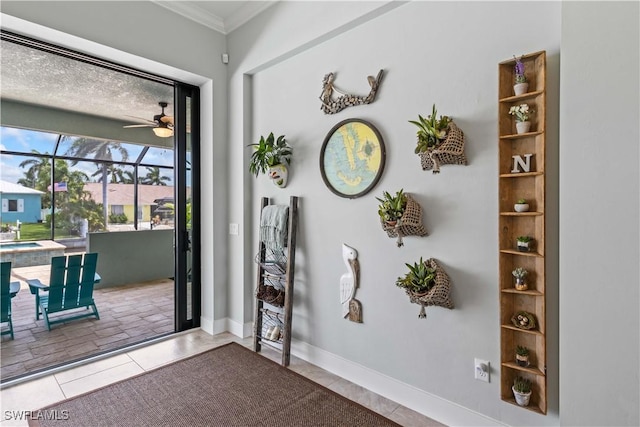 doorway featuring ceiling fan, crown molding, and tile patterned floors
