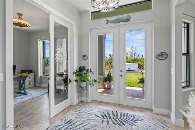 doorway to outside with an inviting chandelier and french doors