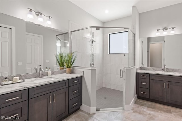 bathroom with a shower with door and vanity