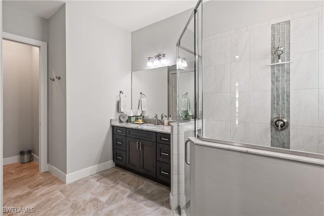 bathroom featuring walk in shower and vanity