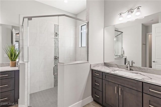 bathroom with walk in shower and vanity