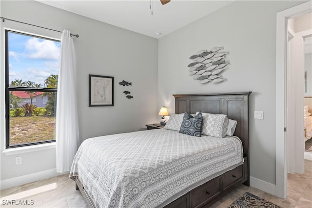 tiled bedroom featuring ceiling fan