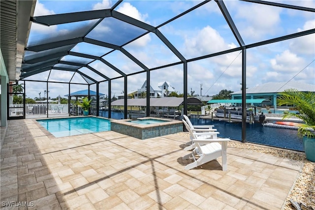view of swimming pool featuring glass enclosure, a water view, an in ground hot tub, and a patio