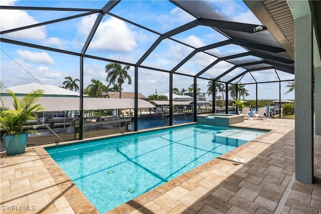 view of swimming pool featuring a lanai, a water view, a patio area, and an in ground hot tub