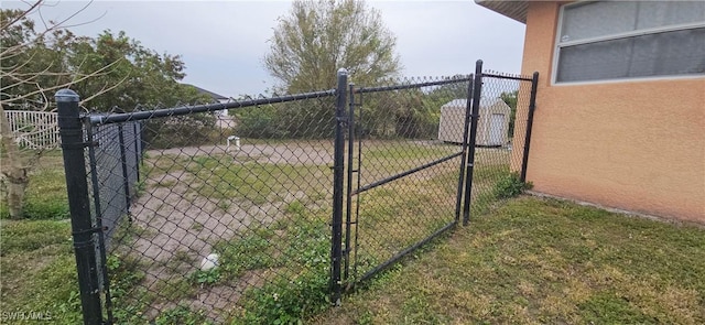 view of gate featuring a yard