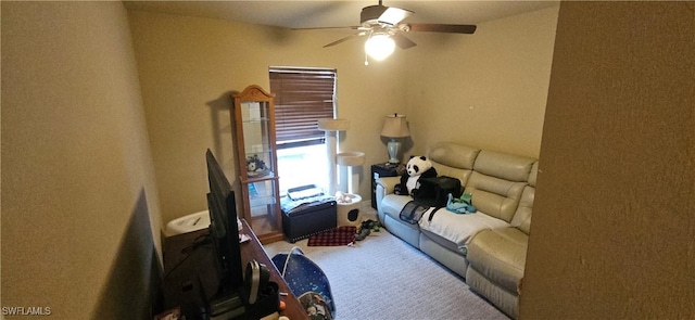 living room with ceiling fan and carpet