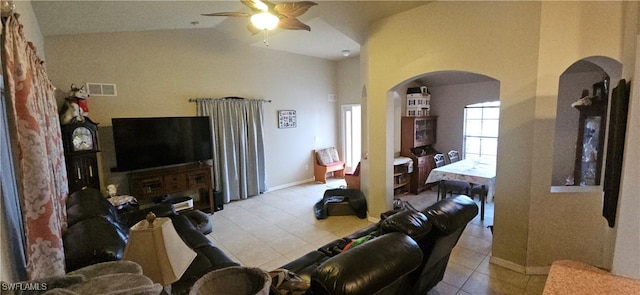 living room featuring ceiling fan, light tile patterned floors, and lofted ceiling