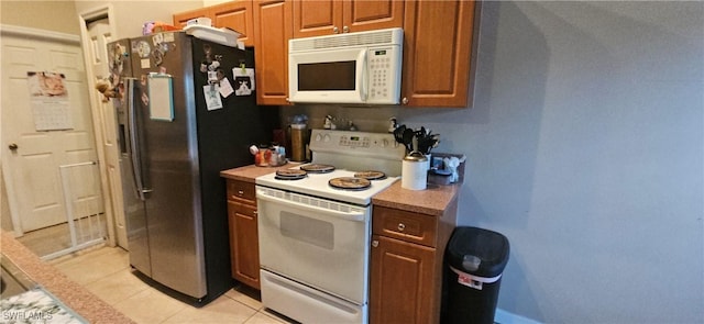 kitchen with light tile patterned floors and white appliances