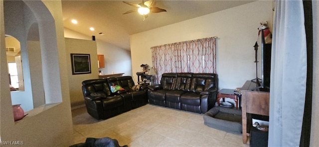 tiled living room with ceiling fan and vaulted ceiling