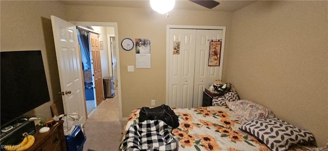 bedroom with ceiling fan and a closet