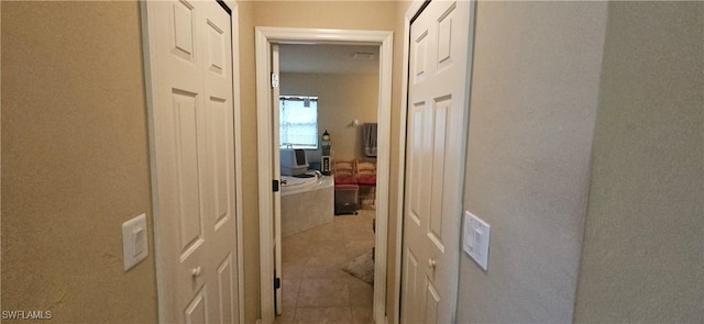 hall with light tile patterned floors