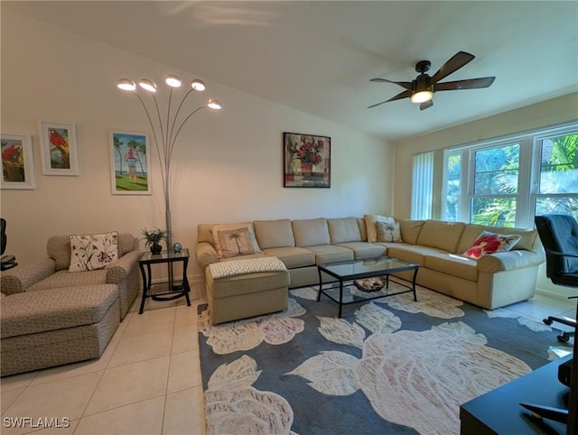 tiled living room with ceiling fan and vaulted ceiling