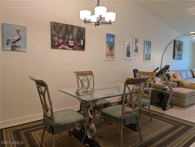 dining area featuring vaulted ceiling, tile patterned floors, and a chandelier