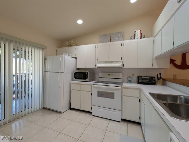 kitchen with white appliances, lofted ceiling, white cabinetry, sink, and light tile patterned flooring