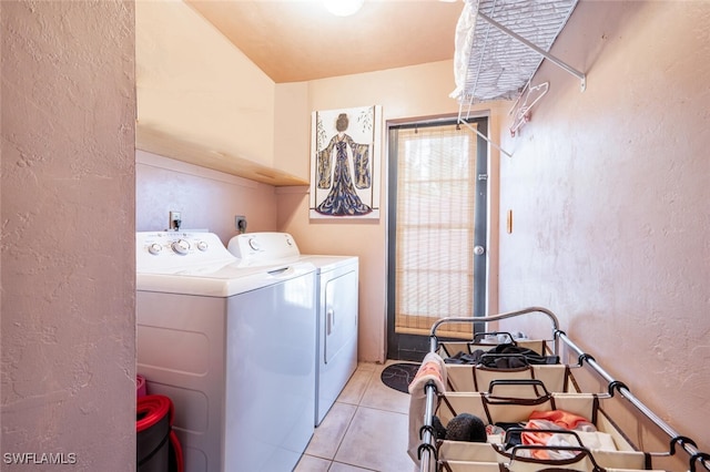 laundry room featuring washer and dryer and light tile patterned flooring