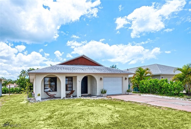 view of front of property featuring a front yard and a garage