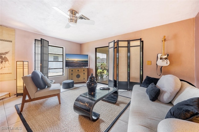 living room with ceiling fan and light tile patterned floors