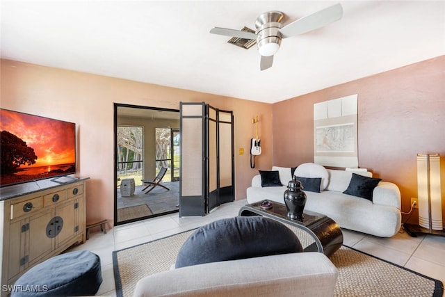 tiled living room with ceiling fan