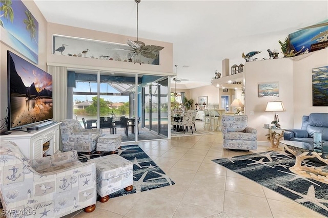 tiled living area with ceiling fan