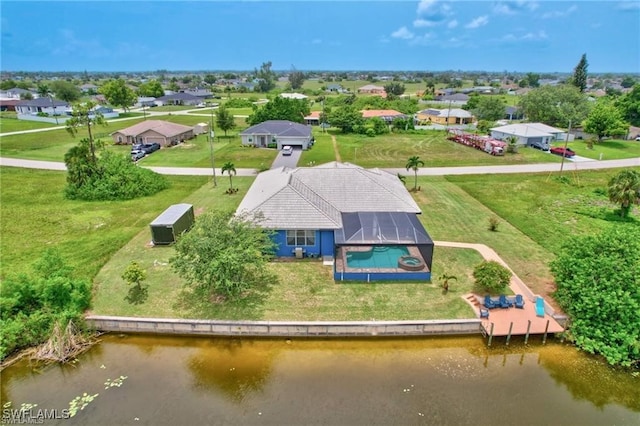 birds eye view of property with a residential view and a water view