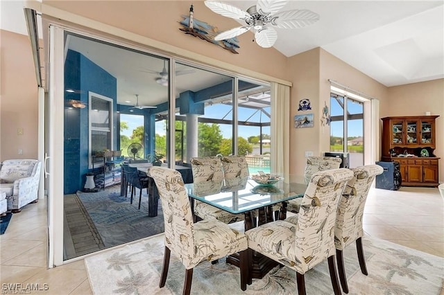 dining space featuring light tile patterned floors, ceiling fan, and a sunroom