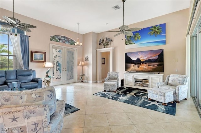 living room featuring tile patterned floors, french doors, visible vents, and ceiling fan with notable chandelier