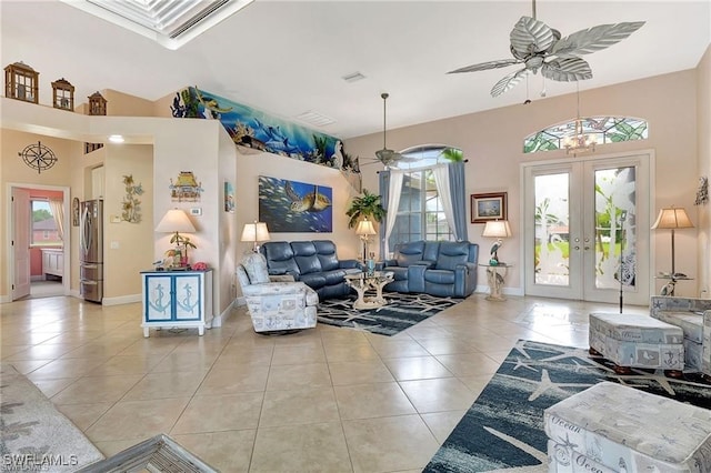 living area with light tile patterned floors, baseboards, a ceiling fan, and french doors