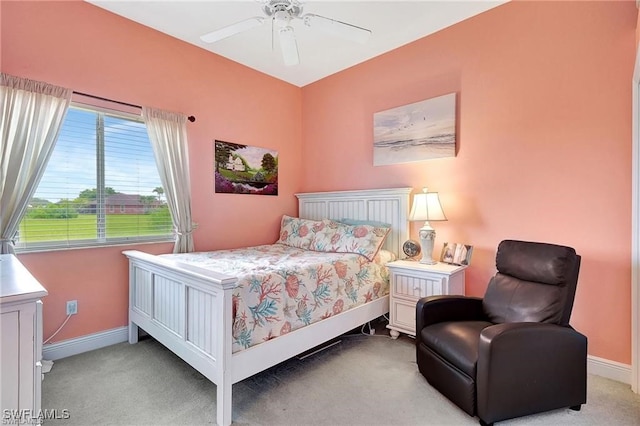 carpeted bedroom featuring baseboards and a ceiling fan