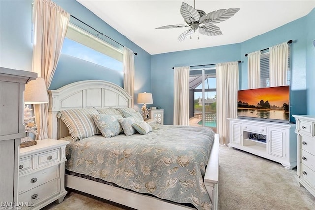 bedroom featuring access to exterior, a ceiling fan, and light colored carpet