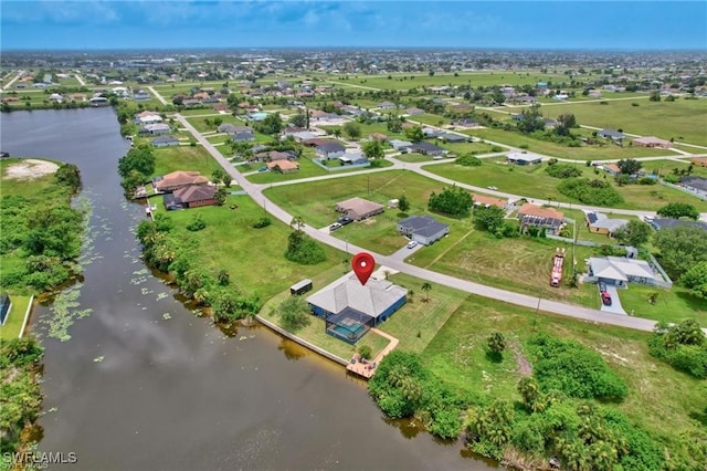 bird's eye view featuring a water view and a residential view