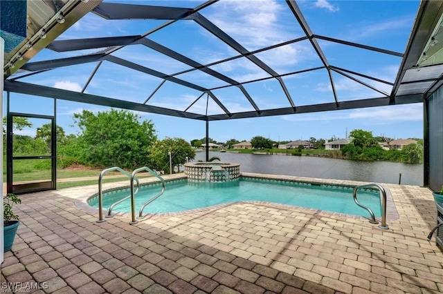 view of pool featuring a patio area, glass enclosure, a water view, and a pool with connected hot tub