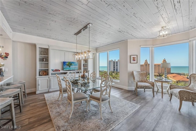 dining room with a notable chandelier, hardwood / wood-style flooring, and wood ceiling