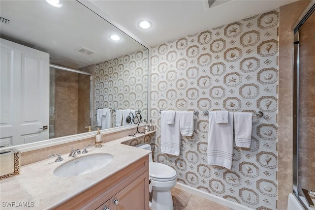 full bathroom with tile patterned flooring, shower / bath combination with glass door, vanity, and toilet