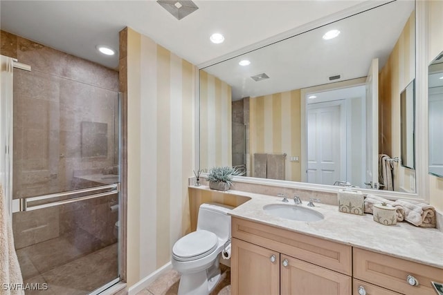 bathroom with toilet, tile patterned flooring, a shower with shower door, and vanity