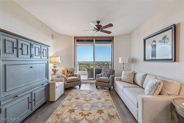 living room with ceiling fan and dark hardwood / wood-style floors