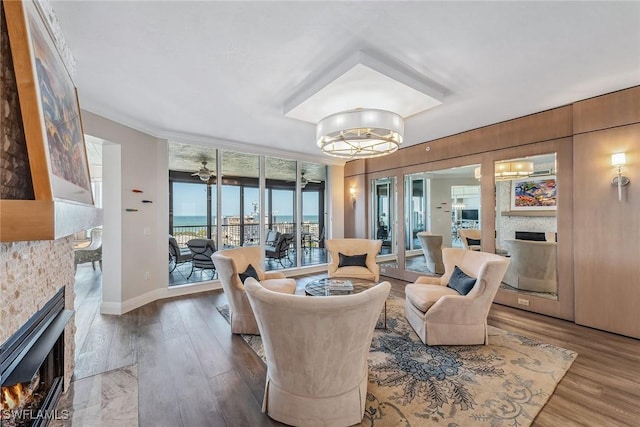 living room with floor to ceiling windows, ceiling fan, hardwood / wood-style floors, and crown molding