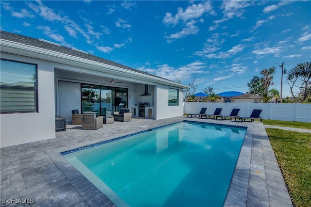 view of swimming pool featuring ceiling fan, a patio area, area for grilling, and outdoor lounge area