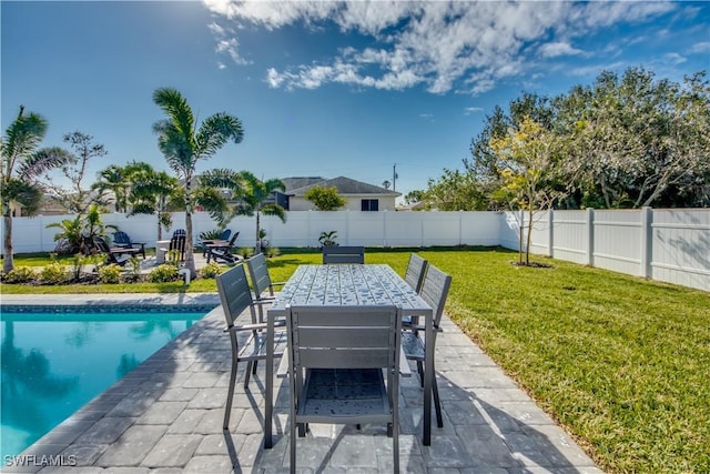 view of swimming pool featuring a patio area and a yard