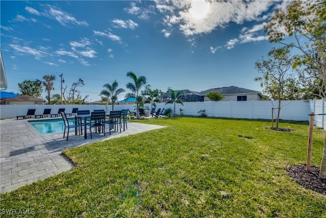 view of yard featuring a fenced in pool and a patio