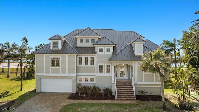 view of front of property featuring a garage and a front lawn