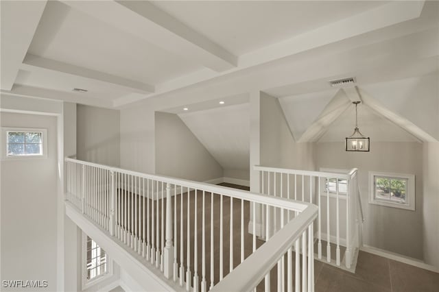 corridor featuring lofted ceiling with beams, plenty of natural light, and a notable chandelier